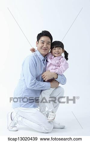 Stock Photo - a father and a daughter hugging. Fotosearch