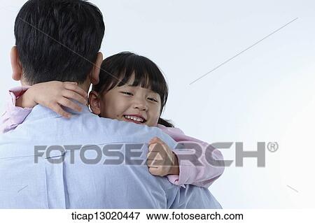 Stock Photo - a father and a daughter hugging. Fotosearch
