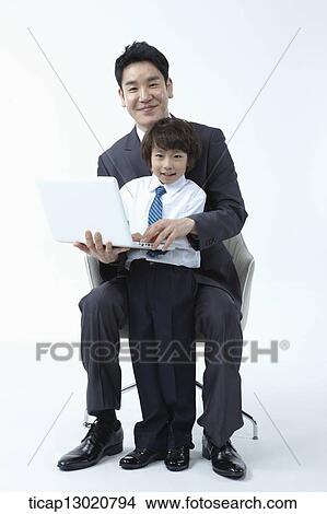 a father and a son dressed up like business men with a laptop View Large Photo Image Picture - a father and a son dressed up like business men with a laptop. Fotosearch