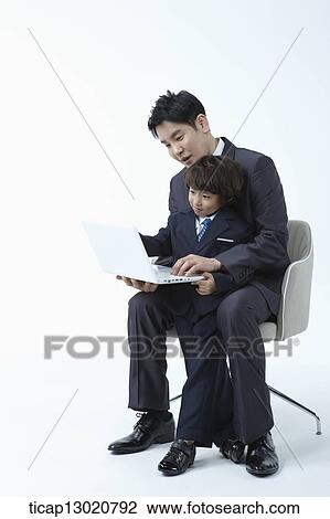 a father and a son dressed up like business men with a laptop View Large Photo Image Stock Image - a father and a son dressed up like business men with a laptop. Fotosearch