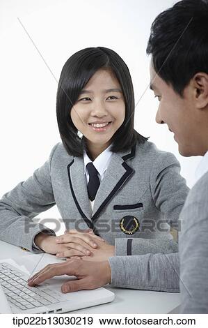Stock Photo - a father helping daughter with homework. Fotosearch