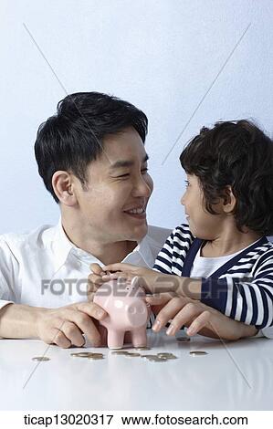 a father helping son to save money View Large Photo Image Stock Photo - a father helping son to save money. Fotosearch