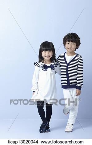Picture - a father hugging daughter and son. Fotosearch