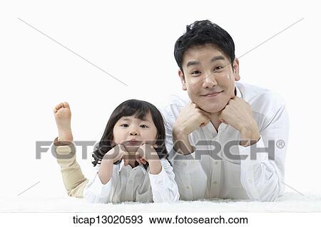 a father lying on the floor with his daughter View Large Photo Image Stock Image - a father lying on the floor with his daughter. Fotosearch
