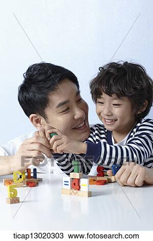 Stock Image - a father playing with his son. Fotosearch