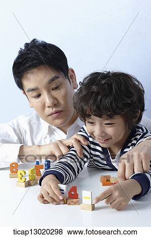 Stock Photo - a father playing with his son. Fotosearch