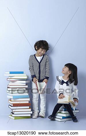 Stock Image - a father reading books with his kids. Fotosearch