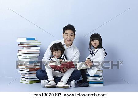 Stock Photo - a father reading books with his kids. Fotosearch