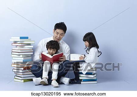 Stock Photography - a father reading books with his kids. Fotosearch