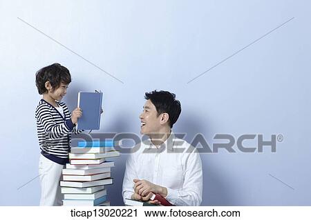 a father reading books with his son View Large Photo Image Stock Image - a father reading books with his son. Fotosearch