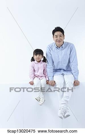 Stock Photography - a father sitting with his daughter. Fotosearch