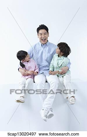 Stock Photo - a father sitting with his kids. Fotosearch