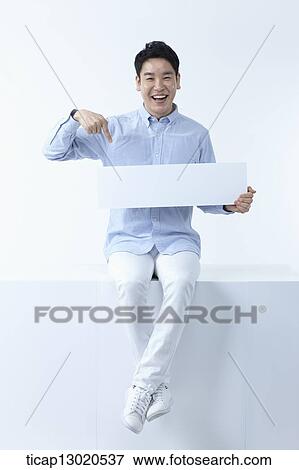 Stock Photo - a father sitting with kids while holding a blank paper. Fotosearch
