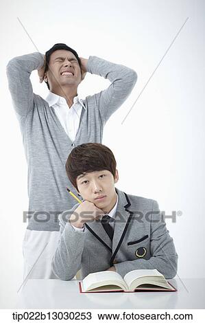 Stock Image - a father with his son doing homework. Fotosearch