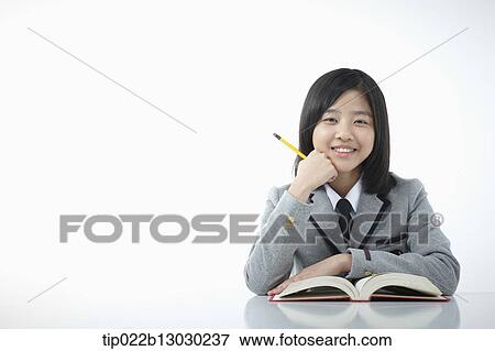 Stock Photo - a girl doing homework. Fotosearch