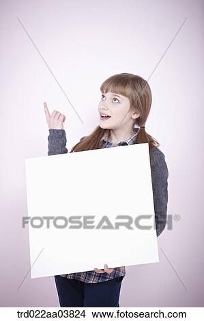 a girl holding a blank piece of paper View Large Photo Image Picture - a girl holding a blank piece of paper. Fotosearch