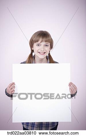 Stock Image - a girl holding a blank piece of paper. Fotosearch