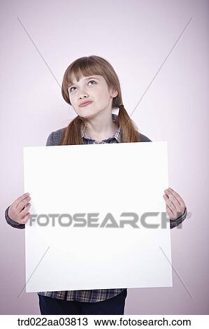 a girl holding a blank piece of paper View Large Photo Image Stock Image - a girl holding a blank piece of paper. Fotosearch