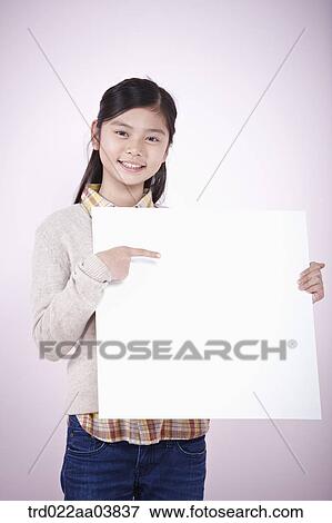 a girl holding a blank piece of paper View Large Photo Image Stock Photo - a girl holding a blank piece of paper. Fotosearch