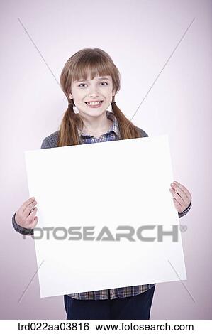 Stock Photograph - a girl holding a blank piece of paper. Fotosearch