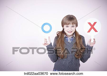 a girl holding boards saying correct and wrong View Large Photo Image Stock Image - a girl holding boards saying correct and wrong. Fotosearch