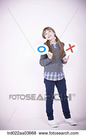 a girl holding boards saying correct and wrong View Large Photo Image Stock Photo - a girl holding boards saying correct and wrong. Fotosearch