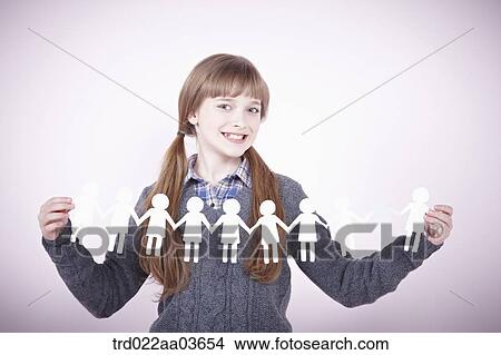 a girl holding continuous paper icons of human View Large Photo Image Picture - a girl holding continuous paper icons of human. Fotosearch