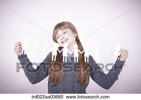 a girl holding continuous paper icons of human View Large Photo Image Stock Image - a girl holding continuous paper icons of human. Fotosearch