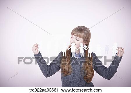 a girl holding continuous paper icons of human View Large Photo Image Stock Image - a girl holding continuous paper icons of human. Fotosearch