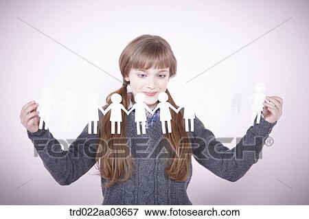 a girl holding continuous paper icons of human View Large Photo Image Stock Photo - a girl holding continuous paper icons of human. Fotosearch