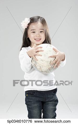 Stock Photograph - a girl hugging a globe. Fotosearch