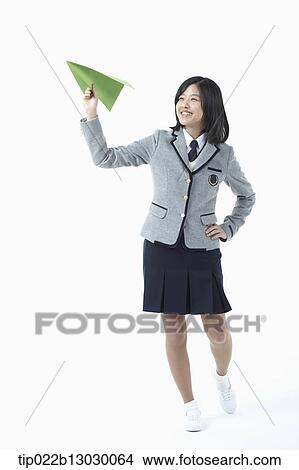 a girl in a school uniform and a paper plane View Large Photo Image Picture - a girl in a school uniform and a paper plane. Fotosearch