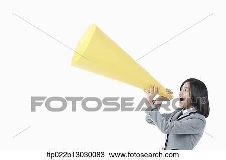 a girl in a school uniform holding a paper megaphone View Large Photo Image Stock Image - a girl in a school uniform holding a paper megaphone. Fotosearch
