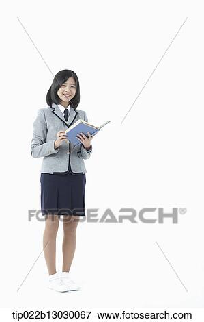 a girl in a school uniform holding a book View Large Photo Image Stock Photo - a girl in a school uniform holding a book. Fotosearch
