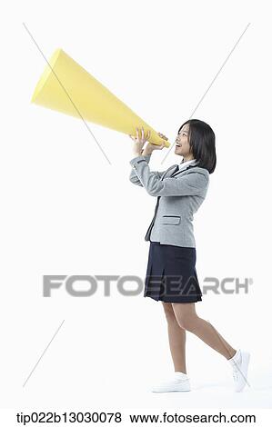 a girl in a school uniform holding a paper megaphone View Large Photo Image Stock Photo - a girl in a school uniform holding a paper megaphone. Fotosearch