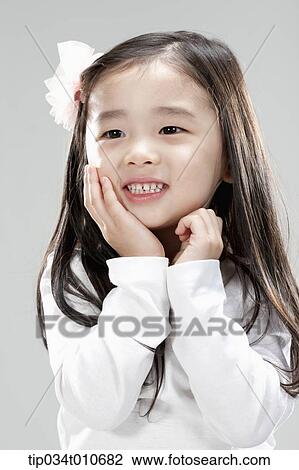 Stock Image - a girl in white shirt smiling. Fotosearch