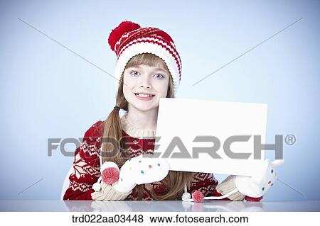 a girl in winter outfit holding a blank board View Large Photo Image Stock Photo - a girl in winter outfit holding a blank board. Fotosearch