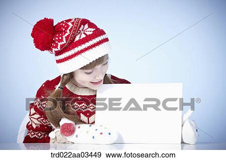 a girl in winter outfit holding a blank board View Large Photo Image Stock Photo - a girl in winter outfit holding a blank board. Fotosearch