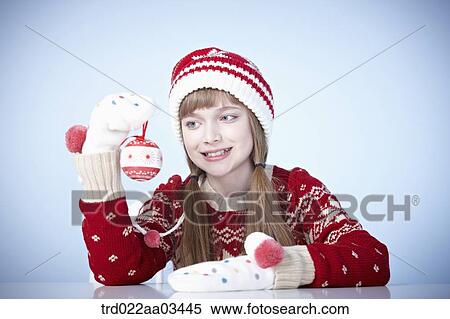 a girl in winter outfit playing with Christmas decoration View Large Photo Image Stock Photography - a girl in winter outfit playing with Christmas decoration. Fotosearch