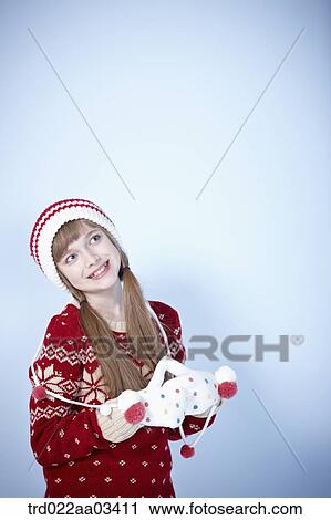 a girl in winter outfit posing on blue background View Large Photo Image Stock Image - a girl in winter outfit posing on blue background. Fotosearch
