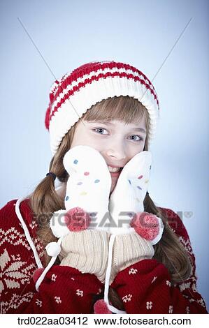 a girl in winter outfit posing on blue background View Large Photo Image Stock Image - a girl in winter outfit posing on blue background. Fotosearch