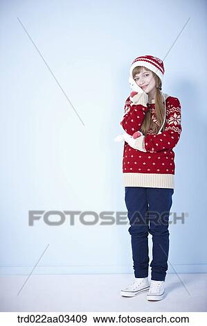 a girl in winter outfit posing on blue background View Large Photo Image Stock Photo - a girl in winter outfit posing on blue background. Fotosearch