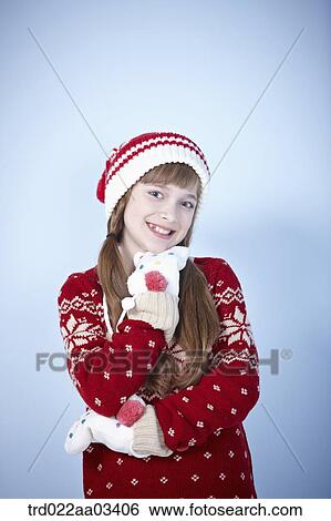a girl in winter outfit posing on blue background View Large Photo Image Stock Photograph - a girl in winter outfit posing on blue background. Fotosearch