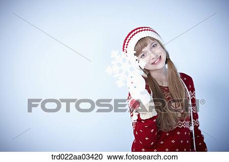 a girl in winter outfit posing with snowflake View Large Photo Image Stock Image - a girl in winter outfit posing with snowflake. Fotosearch