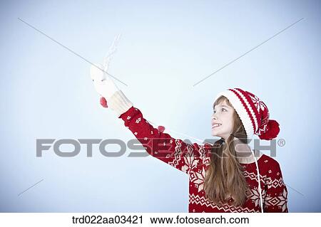 a girl in winter outfit posing with snowflake View Large Photo Image Stock Image - a girl in winter outfit posing with snowflake. Fotosearch