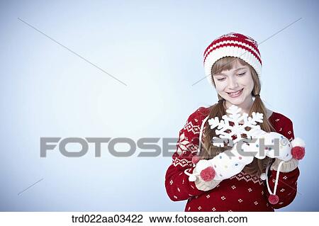 a girl in winter outfit posing with snowflake View Large Photo Image Stock Image - a girl in winter outfit posing with snowflake. Fotosearch