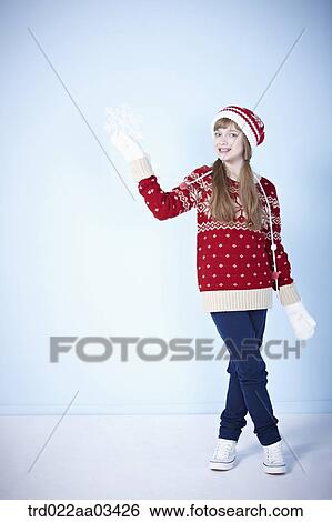 a girl in winter outfit posing with snowflake View Large Photo Image Stock Photograph - a girl in winter outfit posing with snowflake. Fotosearch
