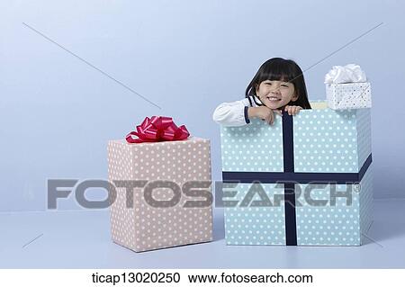 Stock Image - a girl inside a present. Fotosearch