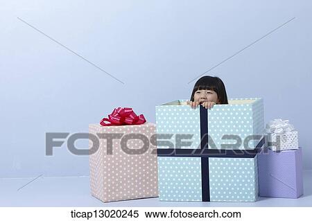 Stock Photography - a girl inside a present. Fotosearch