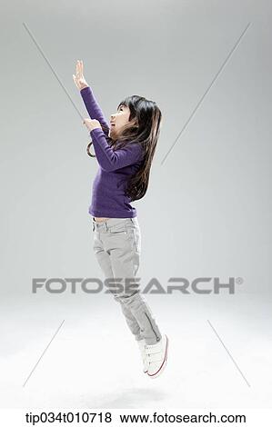 a girl jumping in the air View Large Photo Image Stock Photo - a girl jumping in the air. Fotosearch